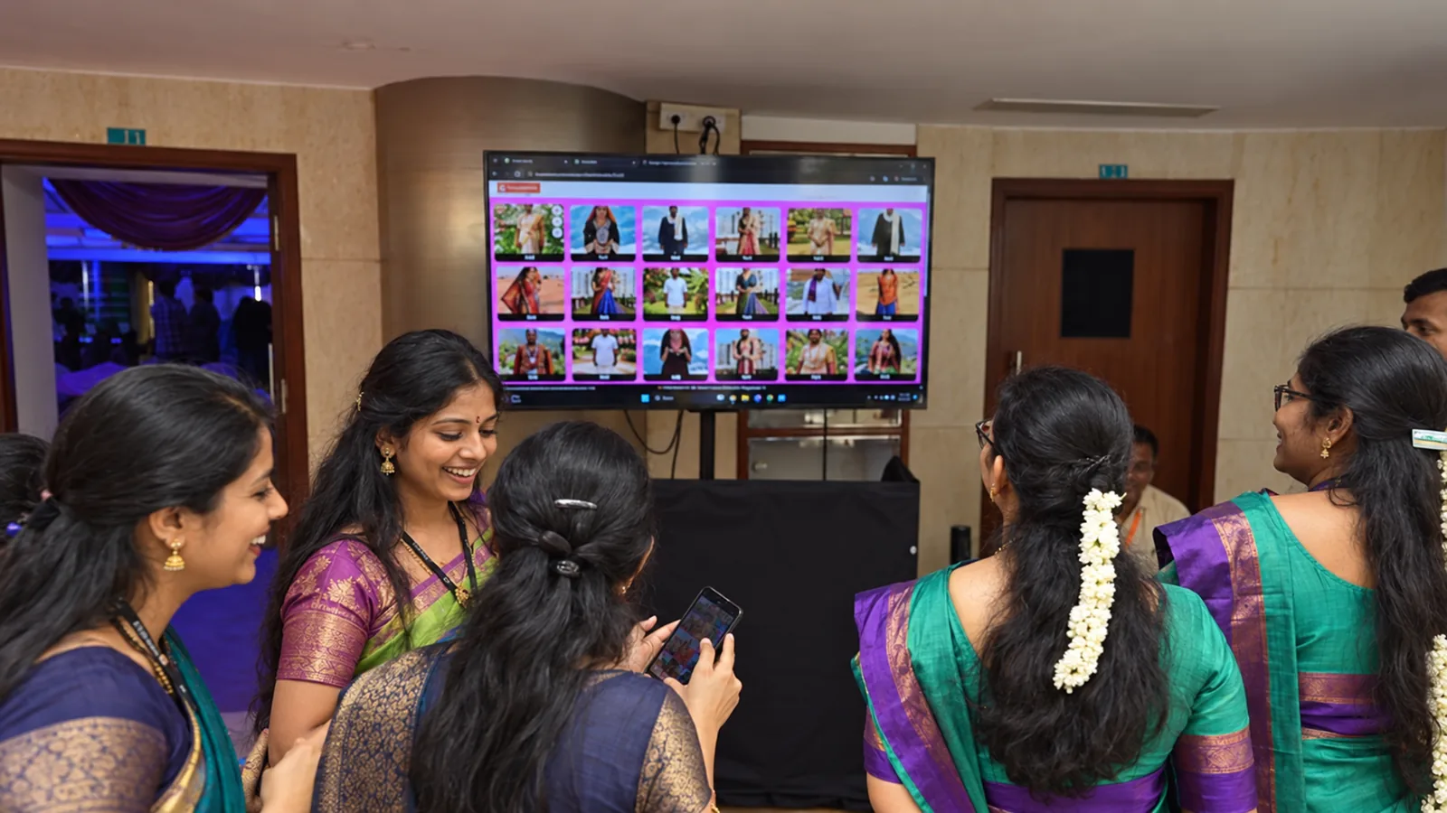 Guests smiling at a screen of AI portraits created by the Playtown AI Photobooth